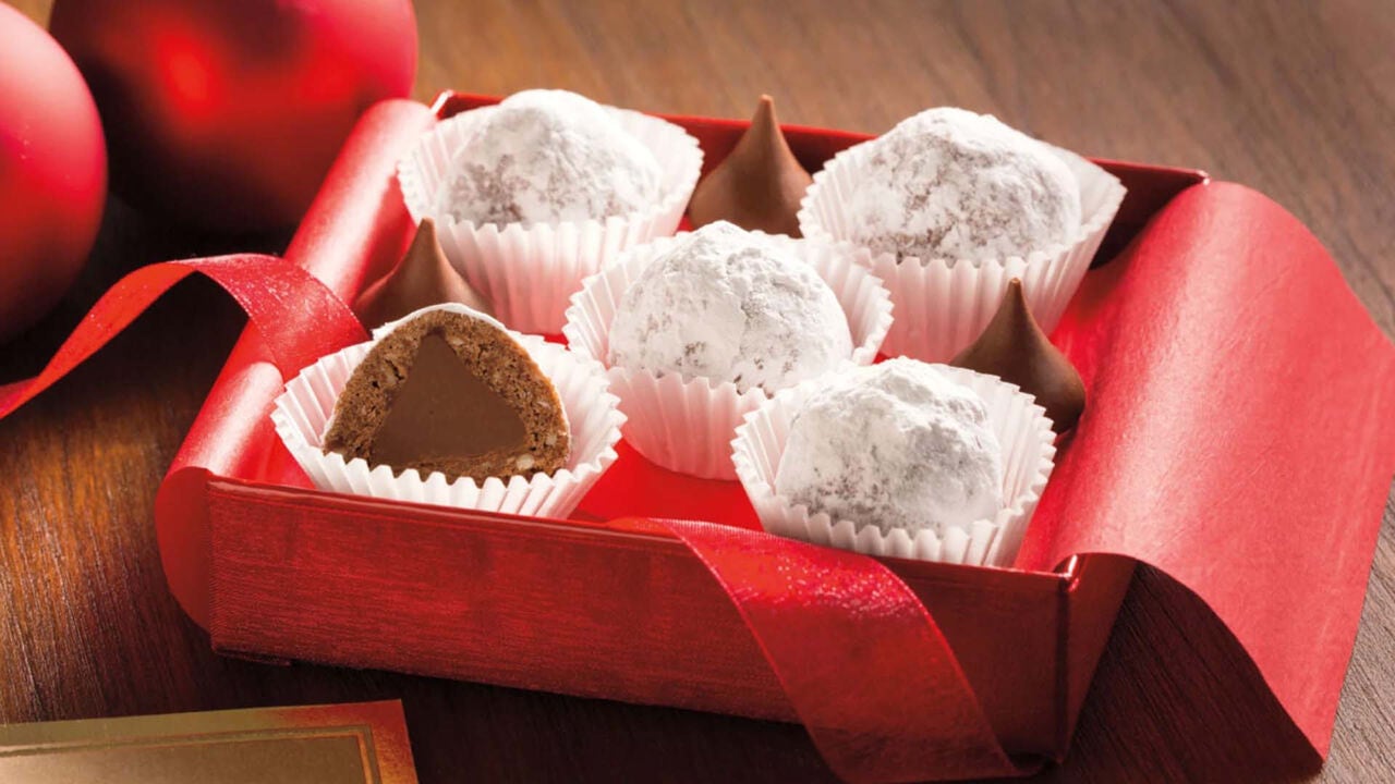 gift box filled with chocolate snowball cookies and hersheys kisses