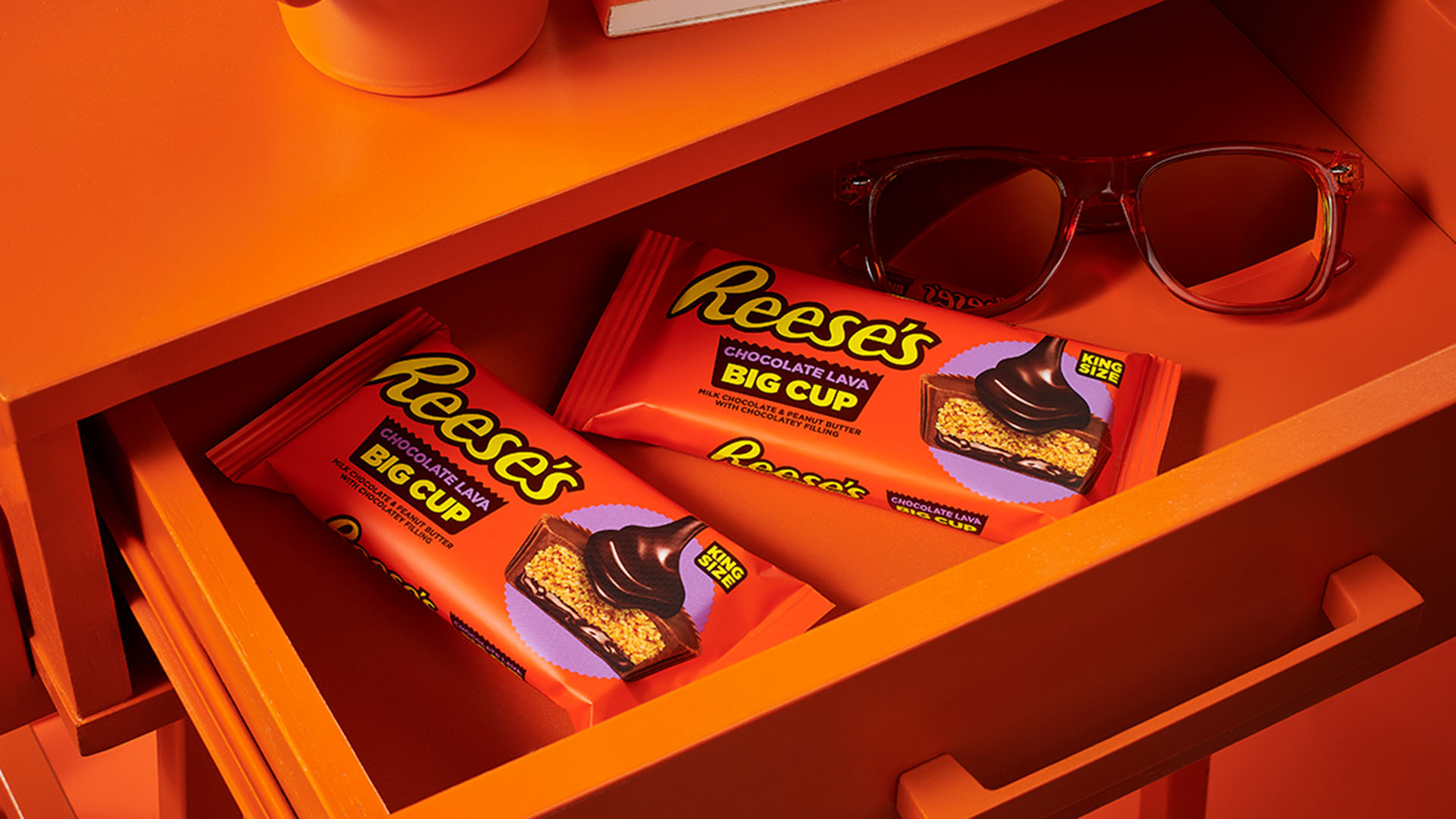 desk drawer filled with king size packs of reeses chocolate lava big cups