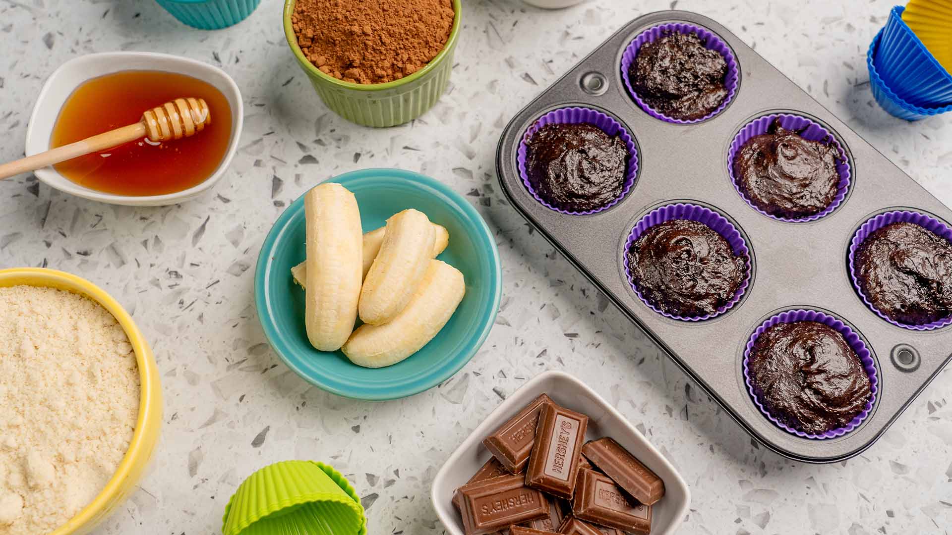 alternative baking ingredients including banana, honey, cocoa, and cupcake batter in reusable silcone cups